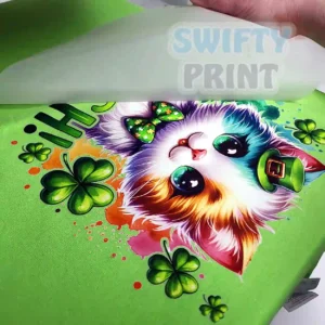 Cat DTF print being printed on green tee by Swifty Print in Cambridge